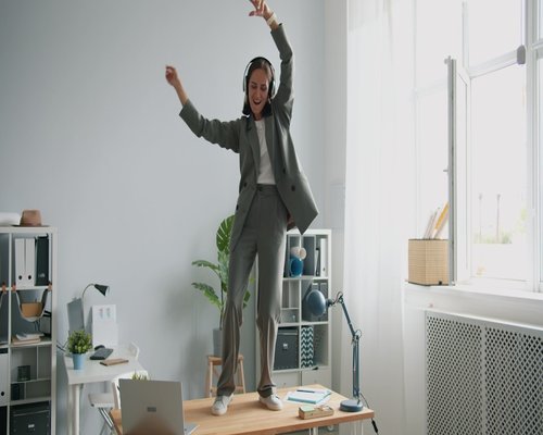 A person stretching lightly during a break in an office environment
